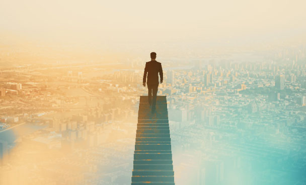 Silhouette of a business man walking up stairs above a cityscape background